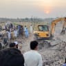 Residents gather as heavy machinery clears the rubble of a damaged police post after a car bombing in Bannu, Khyber Pakhtunkhwa province, Pakistan May 10, 2026. Picture taken with a mobile phone.