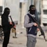 Terrorists from Hamas and Palestinian Islamic Jihad stand on a street during Eid al-Fitr in Gaza City, March 20, 2026. 