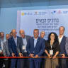 Mayor Moshe Lion and other partners excitedly cutting ribbon at ceremony. At the new space, coffee conversations can lead to groundbreaking results.