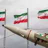 Missiles produced by Iran's armed forces are displayed near a row of Iranian flags during commemorations to mark the anniversary of the 1979 Iranian Revolution on February 11, 2026 in Tehran, Iran.