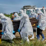 Red Cross workers prepare to lower the coffin of Dr Tibenderana Katho Blaise who worked at the Centre Medical Evangelique (CME) in Hoho commune and died of Ebola virus, at the Nyamurongo cemetery in Bunia town, Ituri province, Democratic Republic of Congo, May 26, 2026. 
