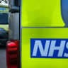 The NHS logo is displayed on a ambulance parked close to a nearby hospital, on October 20, 2025.