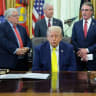US President Donald Trump reacts as he and members of his administration deliver remarks to reporters on the Trump administration's support for coal energy production, among other topics, in the Oval Office at the White House in Washington