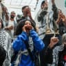 Activists whose Gaza-bound aid flotilla was intercepted by Israeli forces chant while delivering a speech upon their return to the United States at JFK Airport in the Queens borough of New York City, US, May 24, 2026.