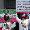 People display placards during a rally in support of US President Trump’s military actions towards Iran, in Toronto, earlier this year.