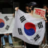 Far-right protesters chant slogans, calling for a halt to vote counting and a rerun of the race, as they surround a polling station where ballot boxes for local elections are still kept in, in Seoul, South Korea, June 4, 2026.