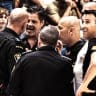 BASKETBALL OFFICIALS and police confer while deciding to halt Game 1 of the semifinals between Hapoel Tel Aviv and Hapoel Jerusalem as fans (inset) exit Yad Eliyahu. (Yehuda Halickman)
