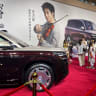People stand near the newly launched N9 electric vehicle (EV) under BYD's premium brand Denza, displayed at a launch event in Guangzhou, Guangdong province, China May 18, 2026.
