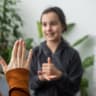 Small Caucasian teen girl child do articulation exercises with caring mother or teacher at home. Little kid pronounce sounds speak talk with tutor or coach, engaged in voice pronunciation together.