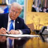 President Donald Trump signs an executive order in the Oval Office at the White House on September 19, 2025 in Washington.