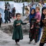 Afghan internally displaced children stand near temporary tents along a river due to the ongoing conflict between Pakistani forces and Taliban security personnel in the Marawara district of Kunar province on April 12, 2026.