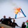 Palestinian demonstrators burn an Israeli flag during a protest against US position on Israeli settlements, in the West Bank city of Nablus, November 26, 2019.