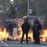 YOUTHS GATHER in front of a burning barricade on Duncairn Gardens on June 9, 2026 in Belfast, Northern Ireland. 