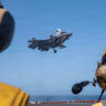 US Sailors observe as a US Marine Corps F-35B stealth fighter lands on the flight deck of USS Tripoli while transiting the Arabian Sea in a photo shared by US Central Command on May 30, 2026.