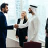 Multiethnic western and middle eastern business team working together in an office of Dubai. Sales people and employees at work on new projects