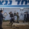 Ultra-Orthodox Jewish protesters demonstrate against the arrest of ultra orthodox jewish men who took part in a protest outside the home of Supreme Court Justice Noam Sohlberg and were later handed over to the military police, outside the Abu Kabir detention facility in Tel Aviv, June 10, 2026. 