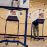 A voter casts their ballot at a polling station during early voting for the mayoral election in Brooklyn, New York City, U.S., October 25, 2025.