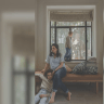 ‘FOR ME, it’s my family first, then nation and border. But he believes that by going to the border, he is defending his family.’ Here, a pregnant Roni sits below her windowsill as one of her children reaches out to her husband, already separated from the family, on his way to his sixth call of duty.