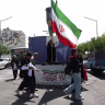 A woman holds an Iranian flag on a street in Tehran, Iran, June 10, 2026. 