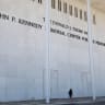 A woman looks up as she passes the front of the John F. Kennedy Memorial Center for the Performing Arts, renamed The Donald J. Trump and The John F. Kennedy Memorial Center for the Performing Arts by the Trump administration, after a federal judge ordered that U.S. President Trump’s name be removed 