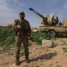 A Syrian army soldier stands guard next to an armoured vehicle positioned along the SyrianLebanese border in the rural area of Al Qusayr on April 1, 2026; Illustrative.