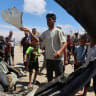Palestinians inspect the site of an Israeli strike on a vehicle in Khan Younis, in the southern Gaza Strip, May 26, 2026.