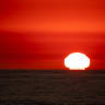 THE SUN sets on the horizon of the Pacific Ocean off the coast of La Jolla during a heat wave during sunset on September 8, 2024 in San Diego, California. 