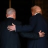 US President Donald Trump and Israeli Prime Minister Benjamin Netanyahu embrace as they walk into Trump's Mar-a-Lago club in Palm Beach, Florida.