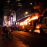 Revellers and fans celebrating the New York Knicks' win over the San Antonio Spurs and World Cup festivities watch as a city shuttle bus catches fire outside the Port Authority Bus Terminal in New York, U.S., June 14, 2026. The shuttles had been brought in to transport spectators to and from the New