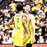 One of Maccabi Tel Aviv players (in yellow) celebrating and one of Hapoel Tel Aviv players (in red) celebrating.