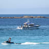 A lifeguard and a NSW Police boat patrol Coogee Beach following a shark attack in Sydney, Australia, June 13, 2026.