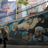 Iranians walk past an anti-Israeli billboard carrying the sentence reading in Farsi, "Israel would not see the next 15 years" erected on the side of a building in Palestine Square in Tehran, on May 28, 2026.