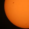 The International Space Station (ISS), (Top-L) transits the sun as seen from Shuwaikh industrial district in Kuwait City on June 14, 2026.