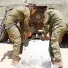 Female IDF soldiers work on a tank; illustrative.