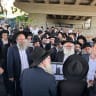 Haredi protestors stand under a bridge, blocking a road near Bnei Brak on Wednesday, 17 June.