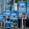 PAKISTAN-WAR-IRAN-US-ISRAEL-DIPLOMACY-TALKS A police personnel walks past posters highlighting Pakistan's mediation of IranUS peace talks, at the Red Zone area in Islamabad on April 18, 2026. No date has been set for the next round of IranUS peace talks brokered by Pakistan following the failure of
