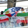 Iran fans display a combined pre-Iranian Revolution "Lion and Sun", Israel and United States flag inside the stadium before a World Cup match.