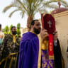 A GREEK Orthodox priest holds up a bible during the Holy Friday service at the Greek Orthodox Monastery of St George in Coptic Cairo on May 3, 2024.
