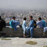 AFGHAN CHILDREN sit on a concrete bench at a hilltop, amid telecom shutdown across the country, in Kabul, Afghanistan, September 30, 2025.