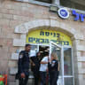 Police outside of the Zol Bagadol supermarket in Jerusalem on June 17, 2026, as law enforcement investigates multiple incidents of children being hospitalized after eating tainted fruit puree.