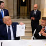 US President Donald Trump holds up the memorandum of understanding, signed by the US, and Iran, at the Palace of Versailles, in France. 