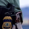 The badge of a US Immigration and Customs Enforcement (ICE) agent is seen at the airport in El Paso, Texas, US, May 10, 2023.
