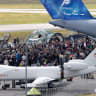 PEOPLE WALK through the static display behind a drone mockup at the International Aerospace Exhibition ILA at Schoenefeld Airport in Berlin, Germany, June 13, 2026. 