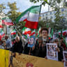 PROTESTORS WAVE flags of the National Council of Resistance of Iran (NCRI) during a demonstration by Franco-Iranian associations, including the Committee to Support Human Rights in Iran (CSDHI) against the capital punishment in Iran, a day after the World Day Against the Death Penalty/