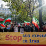 Protestors wave flags of the National Council of Resistance of Iran (NCRI) during a demonstration by Franco-Iranian associations, including the Committee to Support Human Rights in Iran (CSDHI) against the capital punishment in Iran, a day after the World Day Against the Death Penalty.