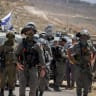 Israeli security forces stand guard as Palestinians and Israeli activists protest against a new Israeli settlement in the village of Deir Abu Mishal, near Ramallah in the West Bank, June 19, 2026.