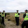 Police officers stand guard, ahead of expected arrival of US President Donald Trump and British Prime Minister Keir Starmer, at Lossiemouth, Scotland, Britain, July 28, 2025. 