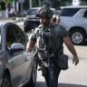 A police officer carries a weapon as he helps after two City of Miami police officers were shot on October 09, 2025, in Miami, Florida. Two City of Miami police officers were shot in the city’s Allapattah neighborhood during an investigation.