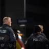 Police stand guard at the main train station of Giessen, Germany. November 29, 2025.
