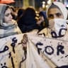 A syrian refugee takes part in a demonstration in Athens calling for women rights on March 8, 2017.